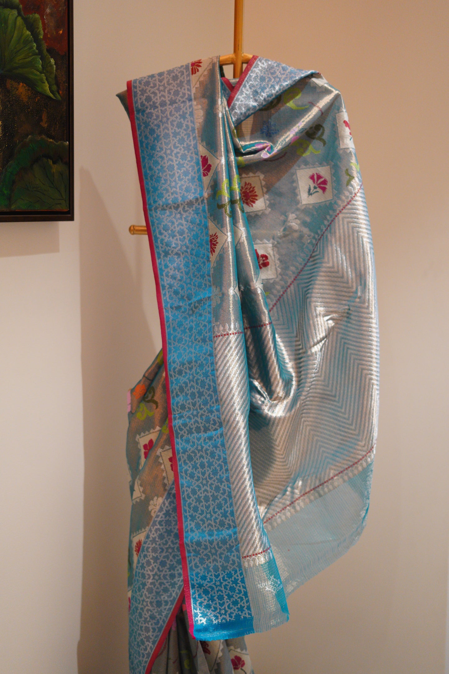 Bright sky blue with hues of red and a jaquard border