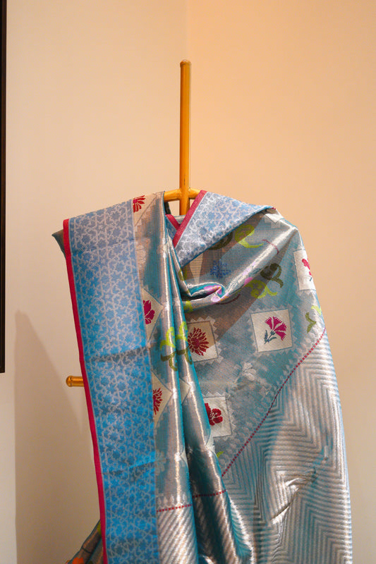 Bright sky blue with hues of red and a jaquard border